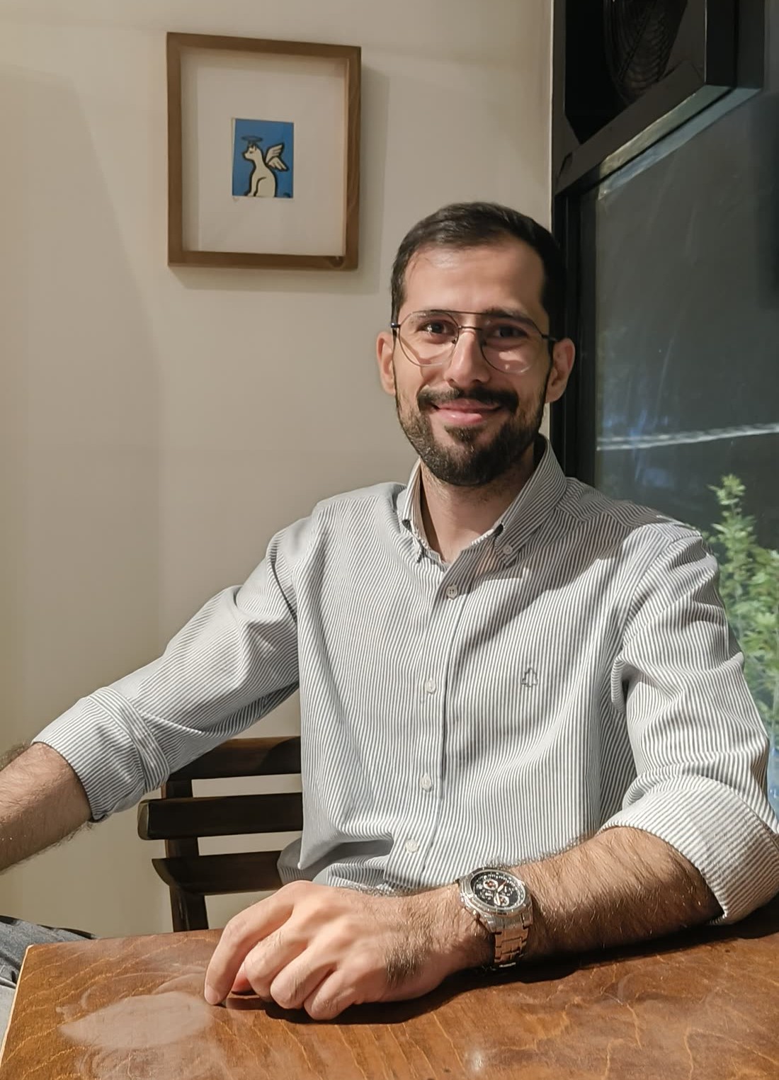 Soroush Jaberi seated at a cafe table